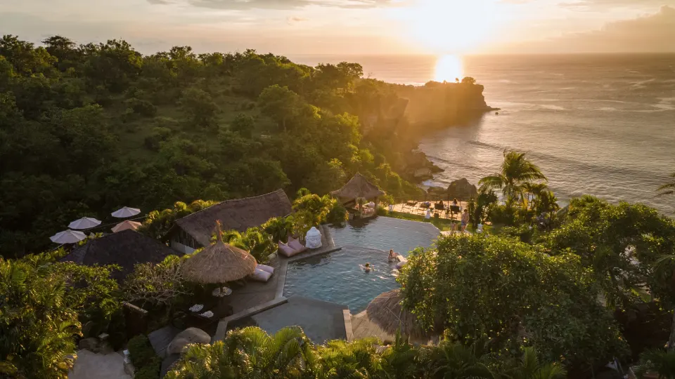 Bali resort at sunset with pool, cliffs and panoramic ocean view