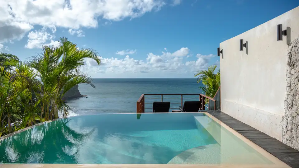 Private pool room in Bali with ocean view and tropical surroundings