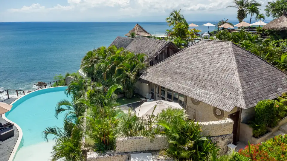 Resort building in Bali surrounded by tropical greenery with ocean view