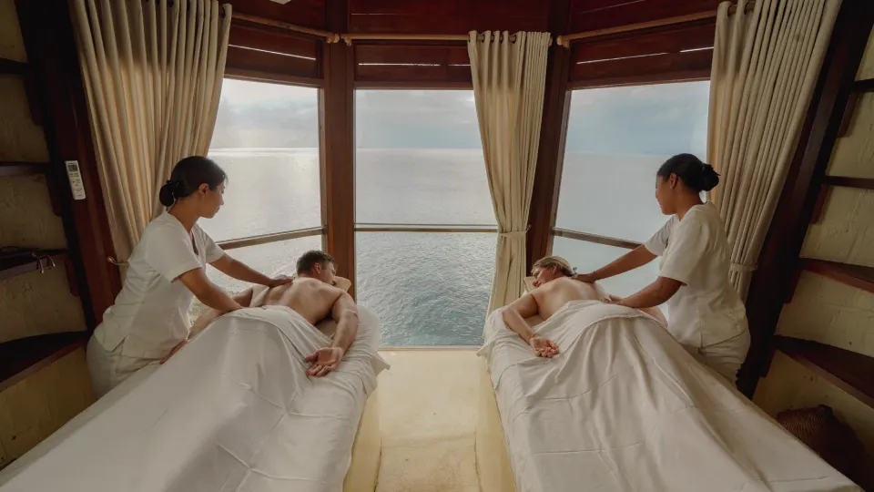 Spa treatment room in Bali with two massage tables facing the ocean