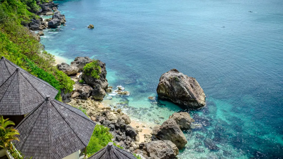 Cliffside ocean view in Bali with turquoise water and large coastal rocks