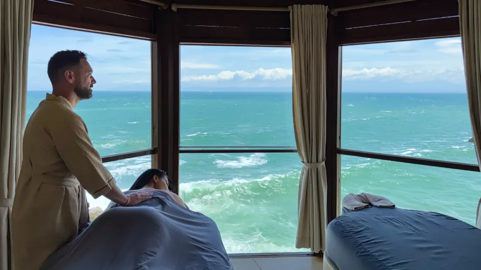 Spa bed in Bali facing the sea through large windows