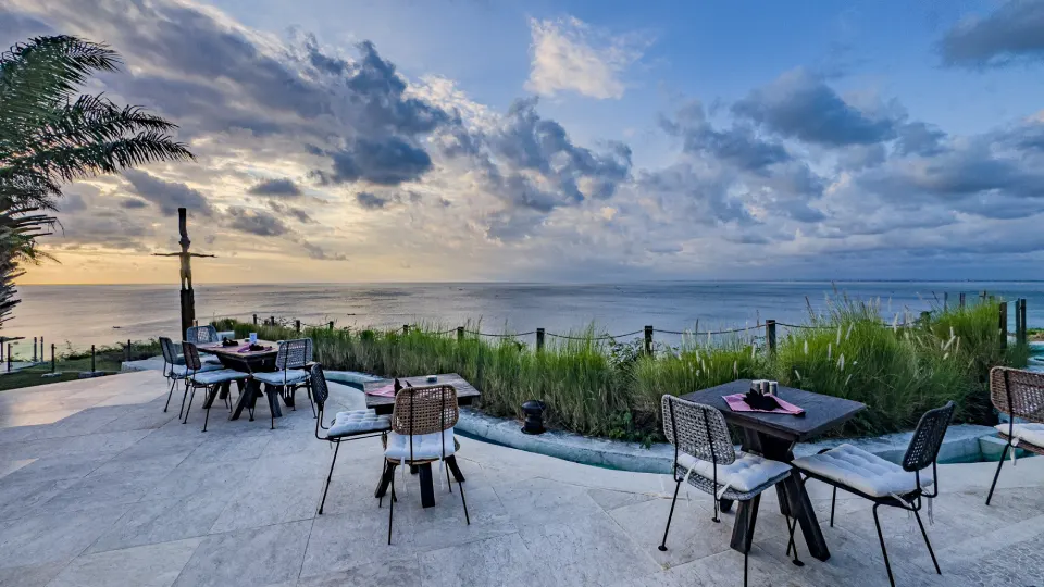 Restaurant terrace in Bali with ocean view and outdoor dining tables