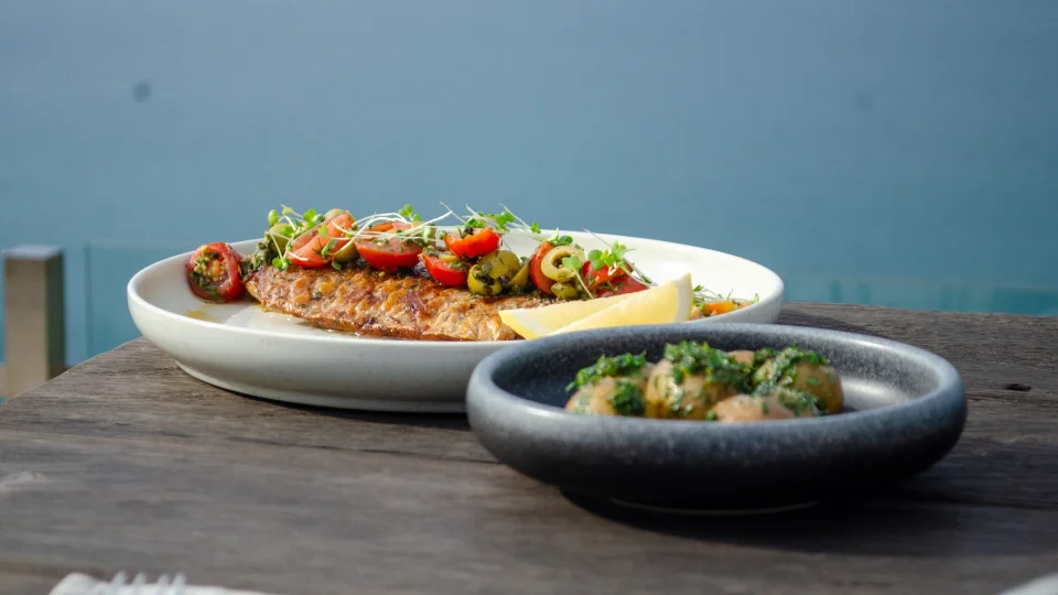 Restaurant dishes served in Bali with ocean view in the background