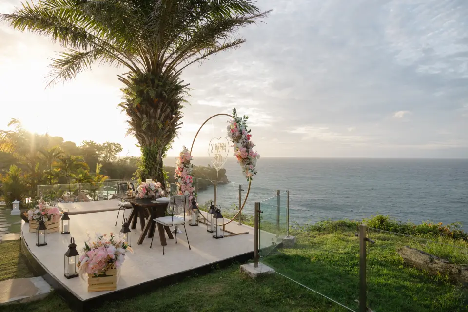 Romantic dinner setup in Bali overlooking the ocean at sunset