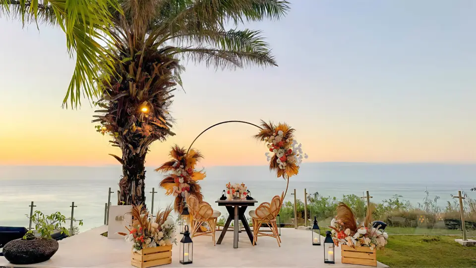 Couple at a romantic candlelit dinner table on the cliff edge