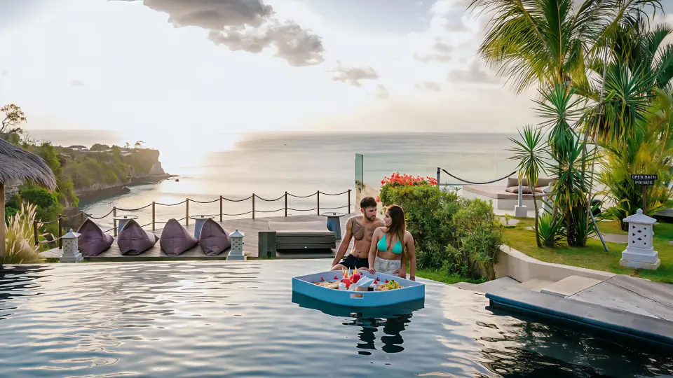 Couple enjoying a floating breakfast tray in the infinity pool