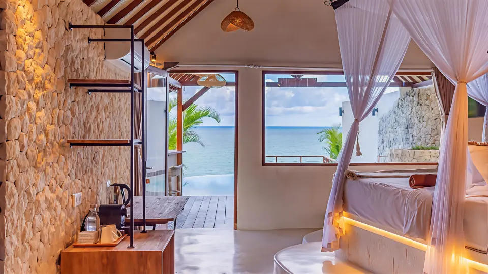 Ocean view lodge bedroom with canopy bed at Biu Biu Resort
